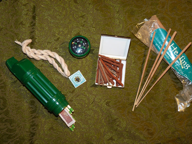 Incense, matches, a whistle/waterproof match holder and compass