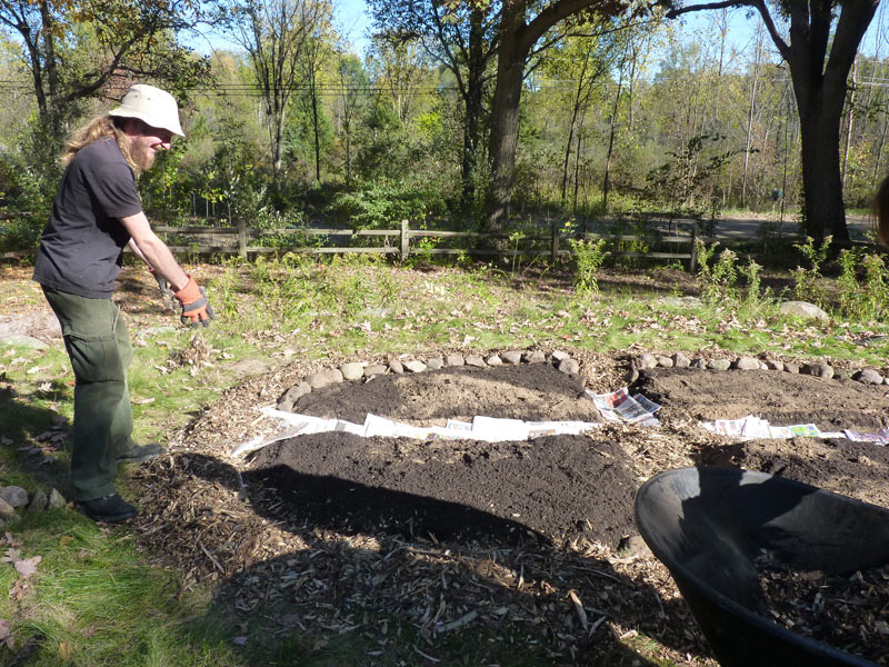 Adding more mulch as the bed takes shape!