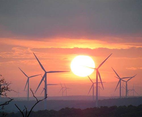 Incredible sunrise in the mountains with the windmills