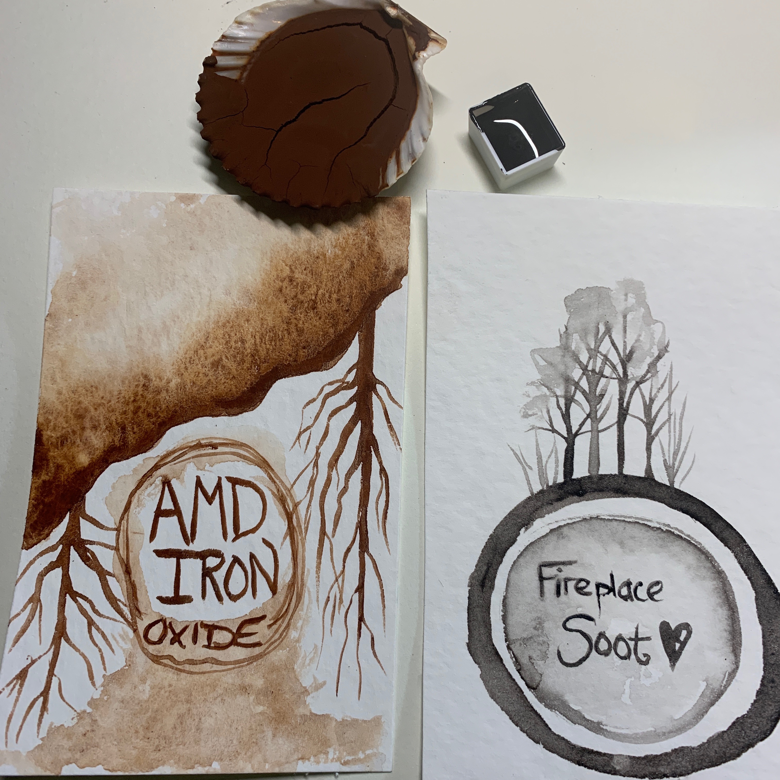 Two finished paints: soot from my fireplace and iron from a local Acid Mine Drainage remediation site