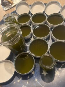 Finished salves in tins and jars ready to share with others!