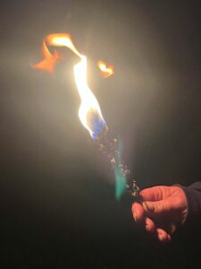 Mullein torch burning in hand