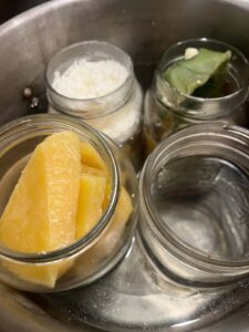 Waxes melting in a water bath. We have three waxes and then one jar of water to keep the other three balanced. 